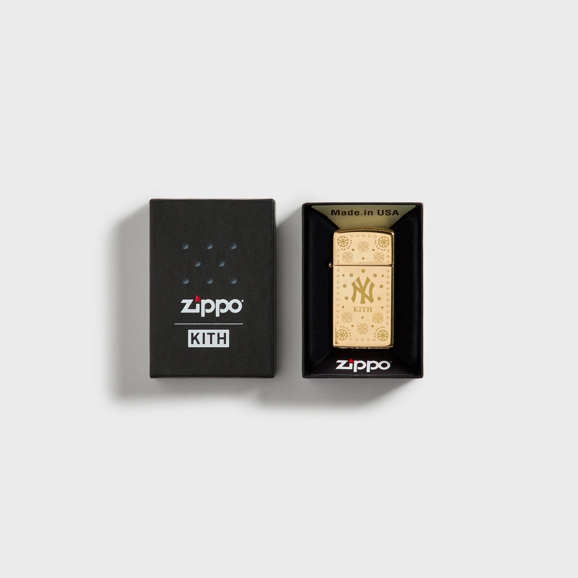 Kith x New York Yankees gold Zippo lighter displayed in open Zippo x Kith packaging box