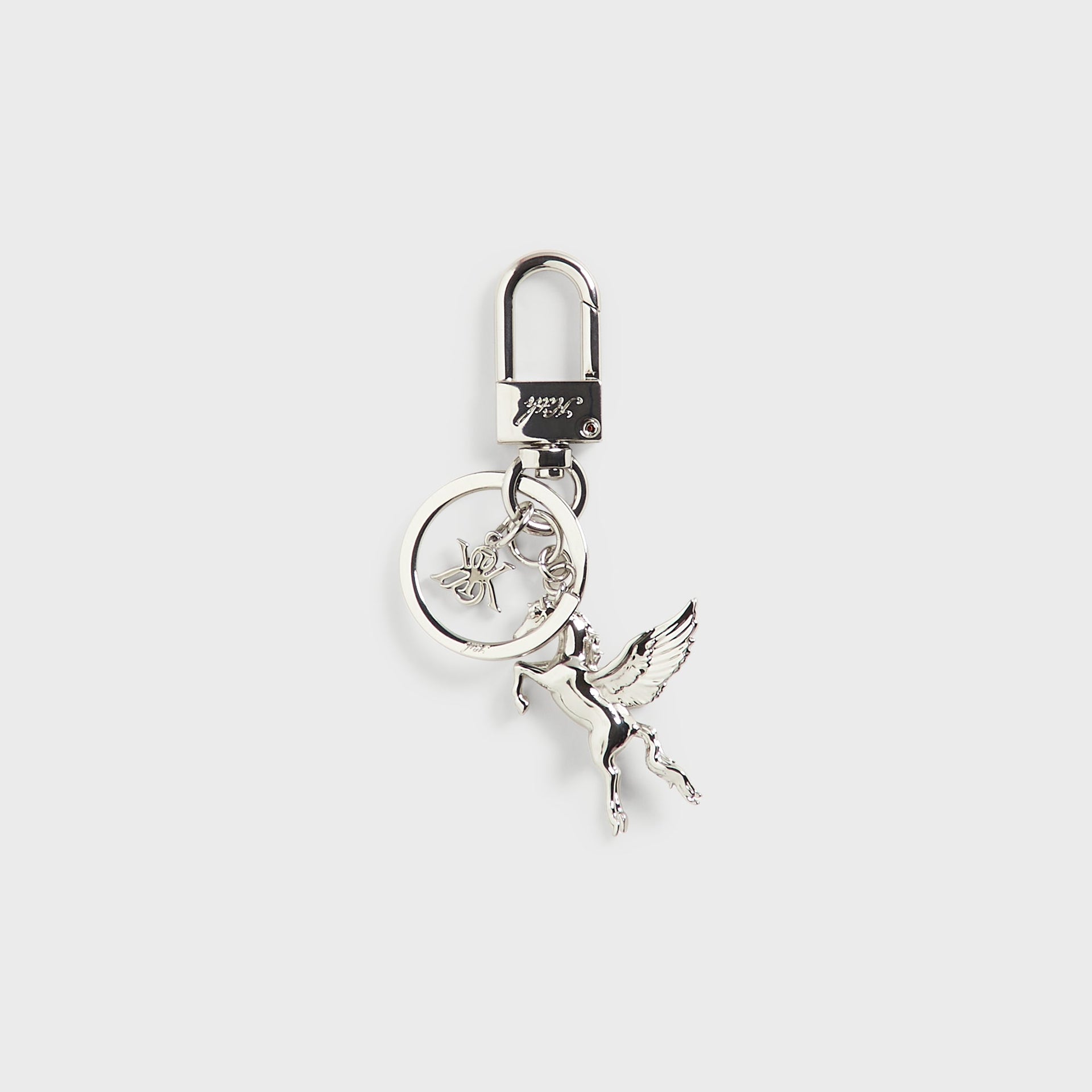 Angled view of the Kith Pegasus Keyring in silver, showing the winged horse charm and keyring hardware from the side