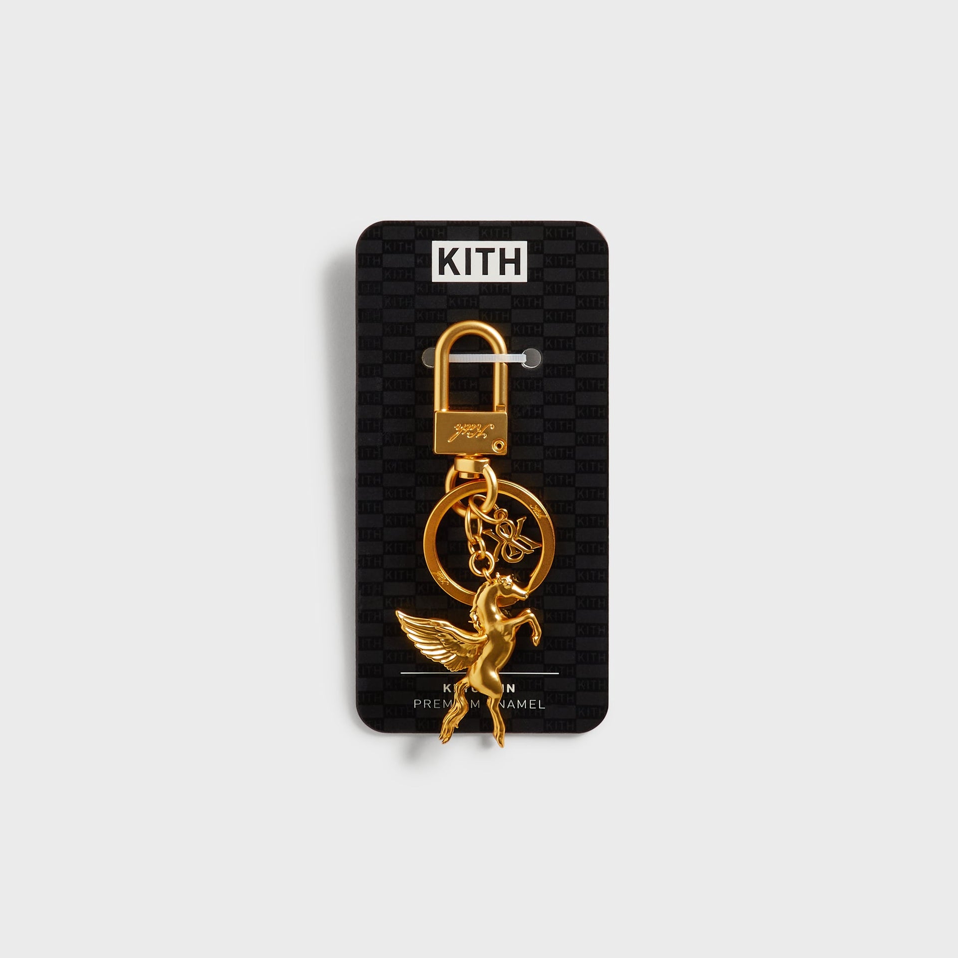 Kith Pegasus Keyring in Gold displayed on branded Kith retail packaging card