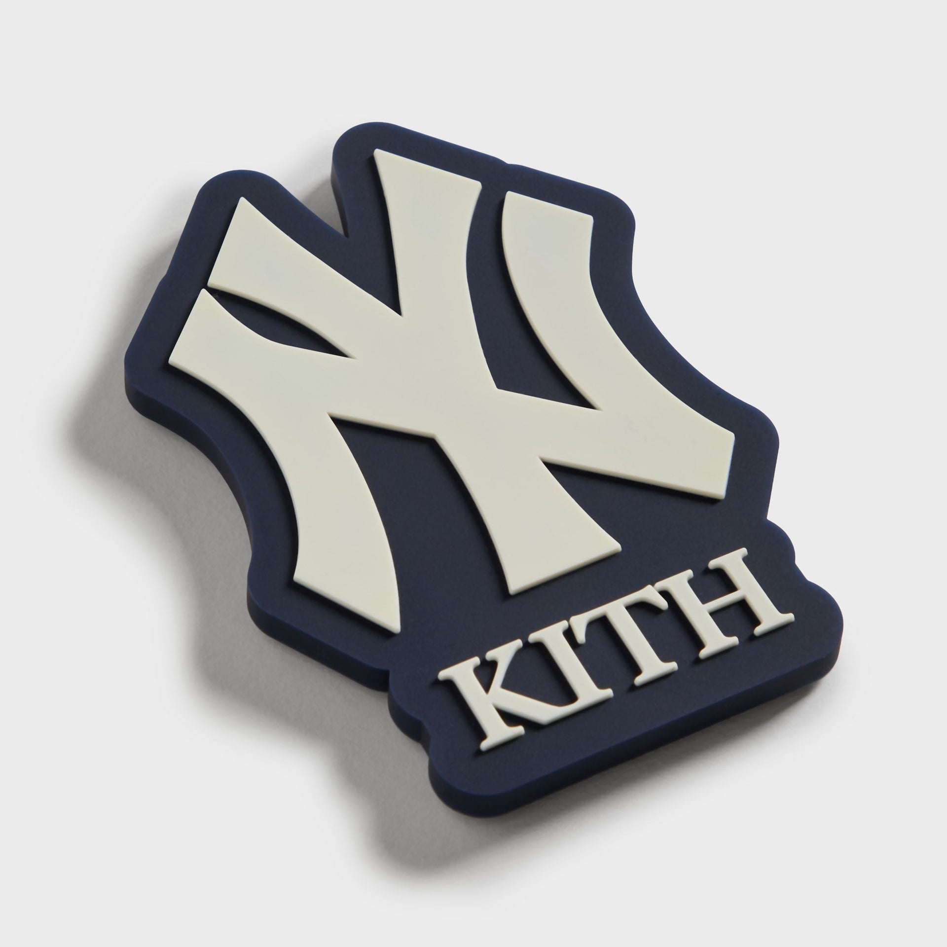 Angled view of the Kith x New York Yankees NY logo fridge magnet