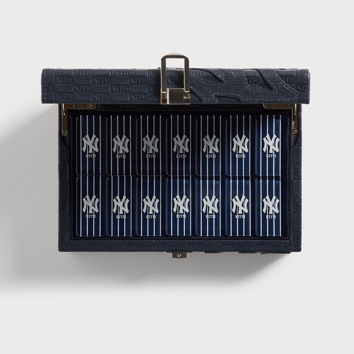 Open Kith x New York Yankees domino case, top-down view of the pinstriped tiles in their tray