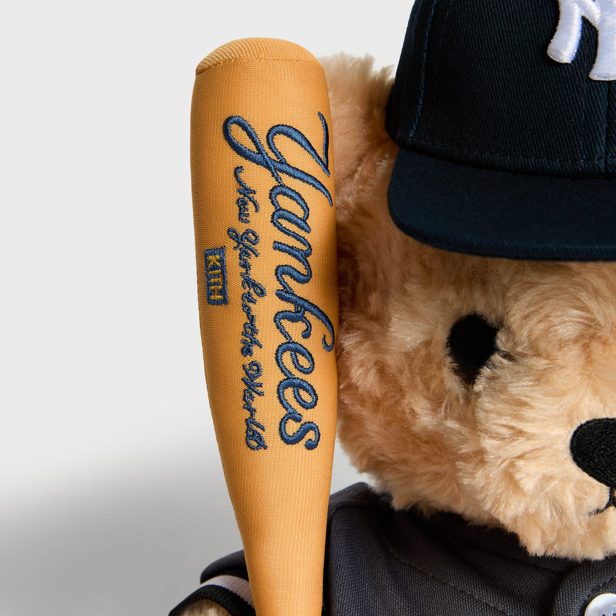 Close-up of Yankees script embroidered on the toy bat handle held by the Skyscraper bear