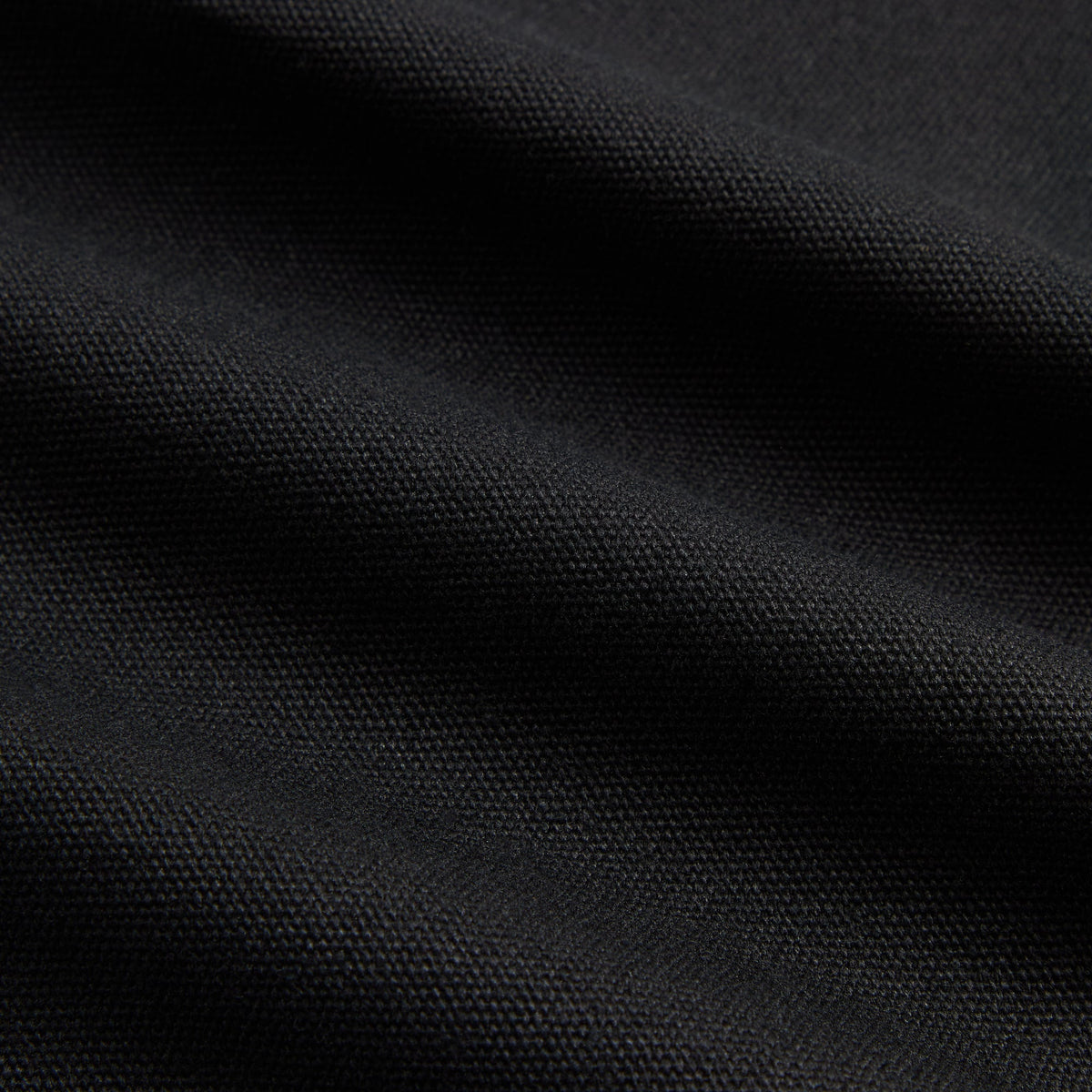 Macro detail of black cotton canvas fabric texture on Kith Treats for Katz's Delicatessen apron