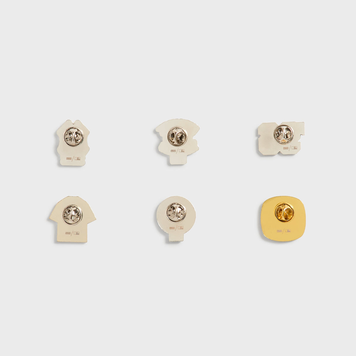 Kith x New York Yankees pin set, back view showing pin posts, clasps, and MLB stamp