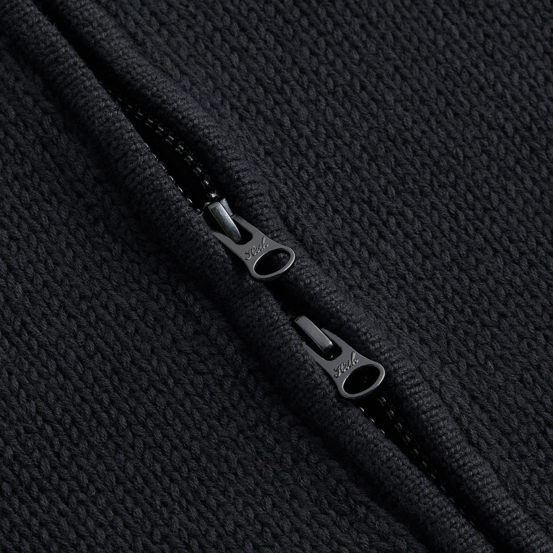 Close-up of the zipper pull on the Kith for Needles Wyona full zip sweater