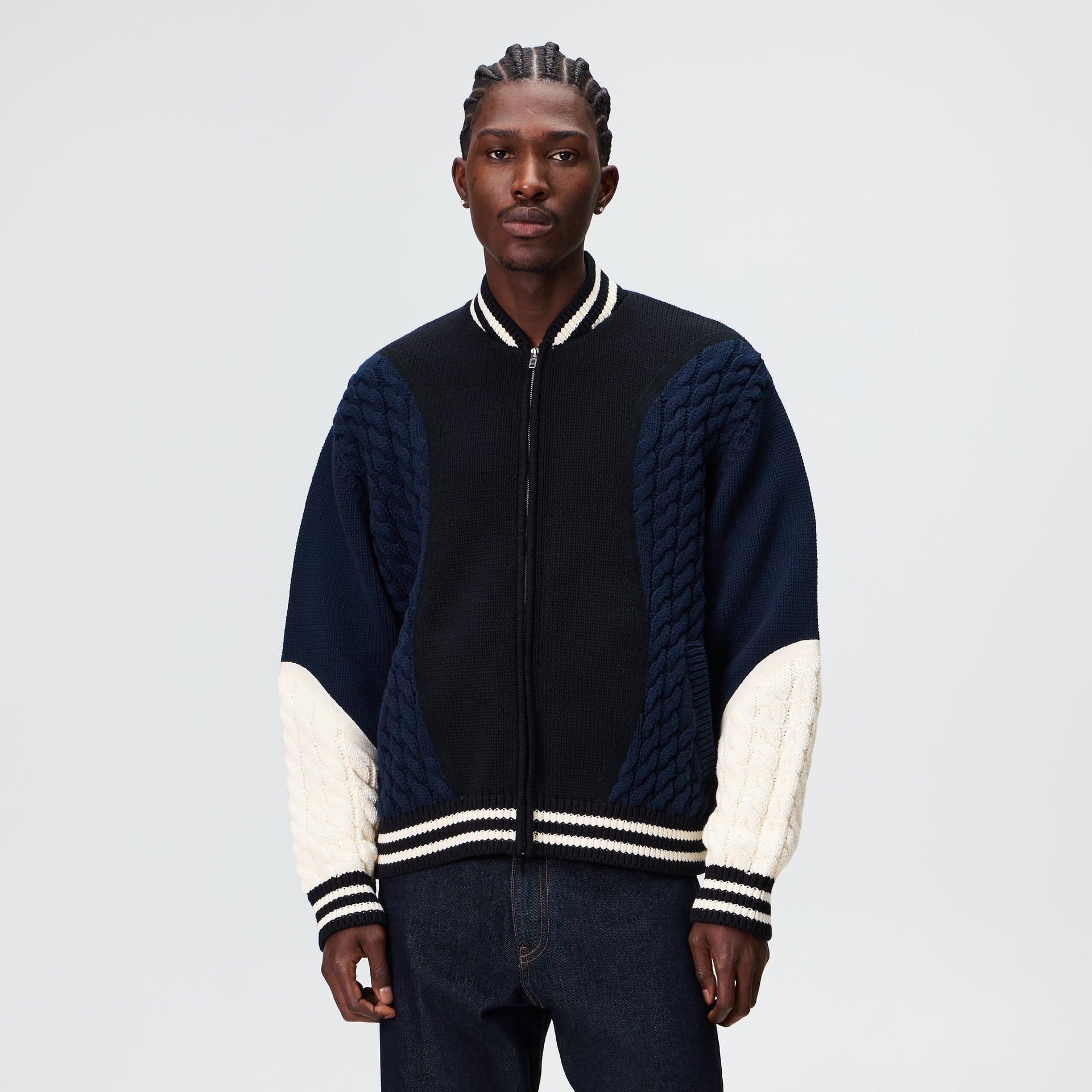 Man wearing the Kith for Needles Wyona full zip sweater in black and navy, front view
