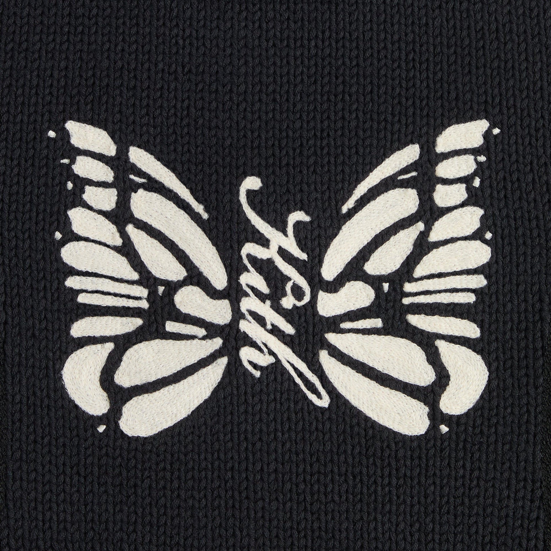 Close-up of the cream butterfly knit graphic with Kith script on the Wyona full zip sweater