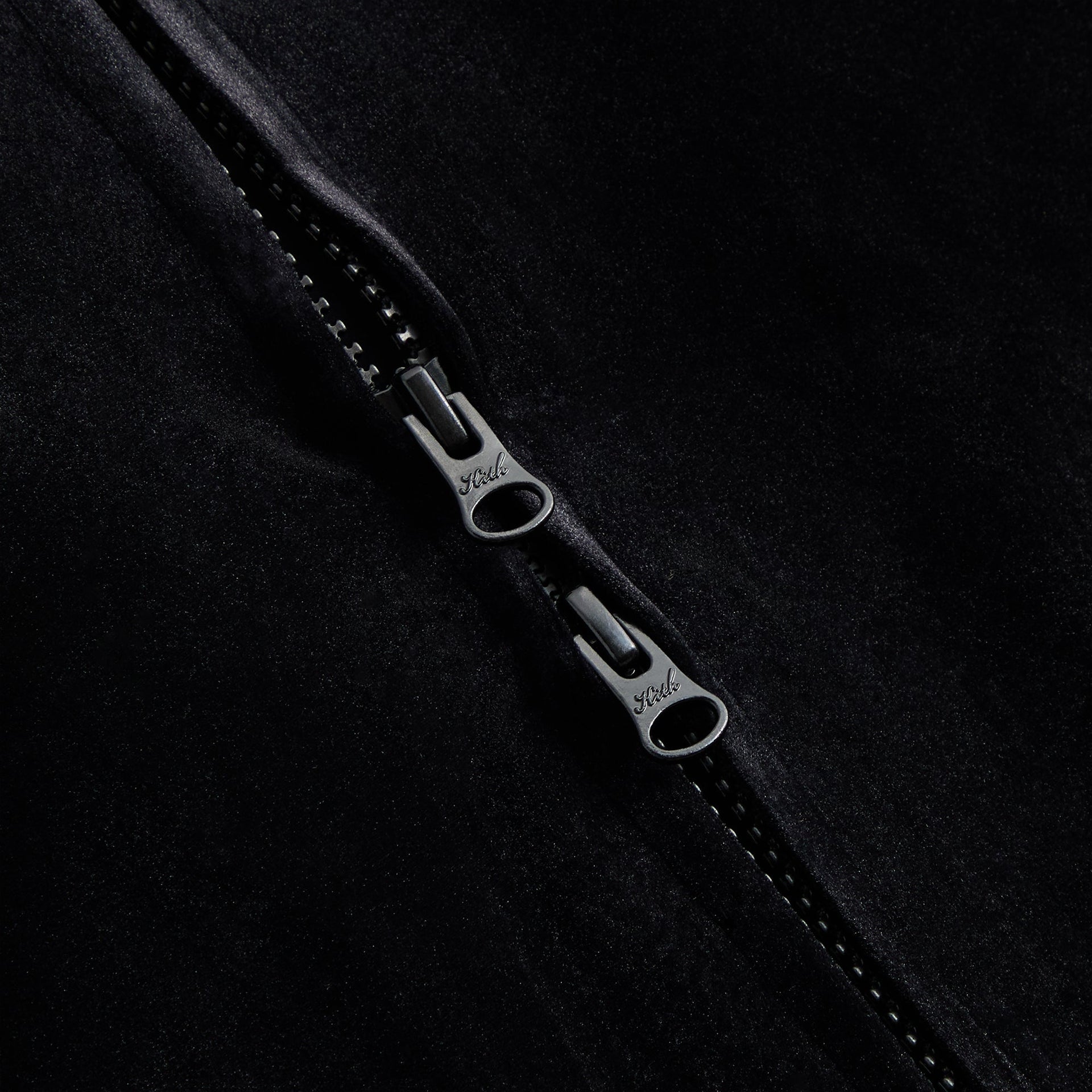 Close-up of the zipper pull on the Kith for Needles Rui track jacket in black velour