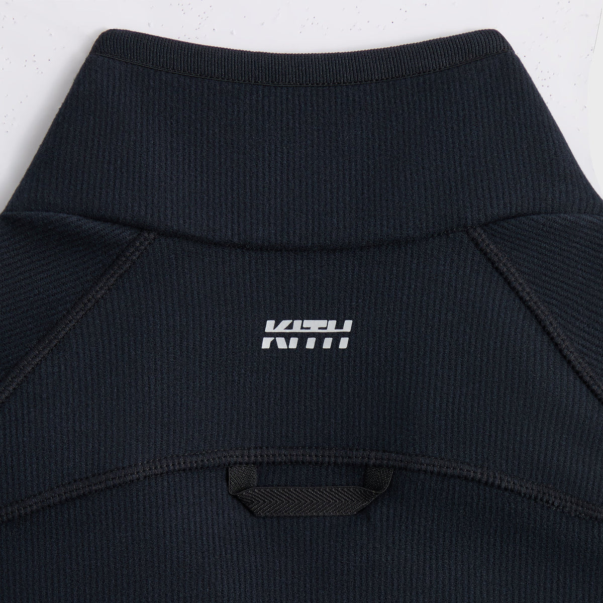 Close-up of Kith Calix Quarter Zip mesh underarm ventilation panel
