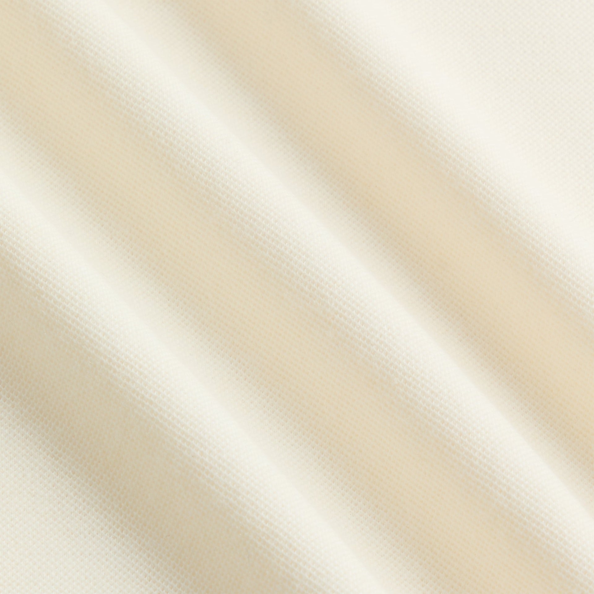 Close-up of cream pique knit fabric of the &Kin Melton Polo
