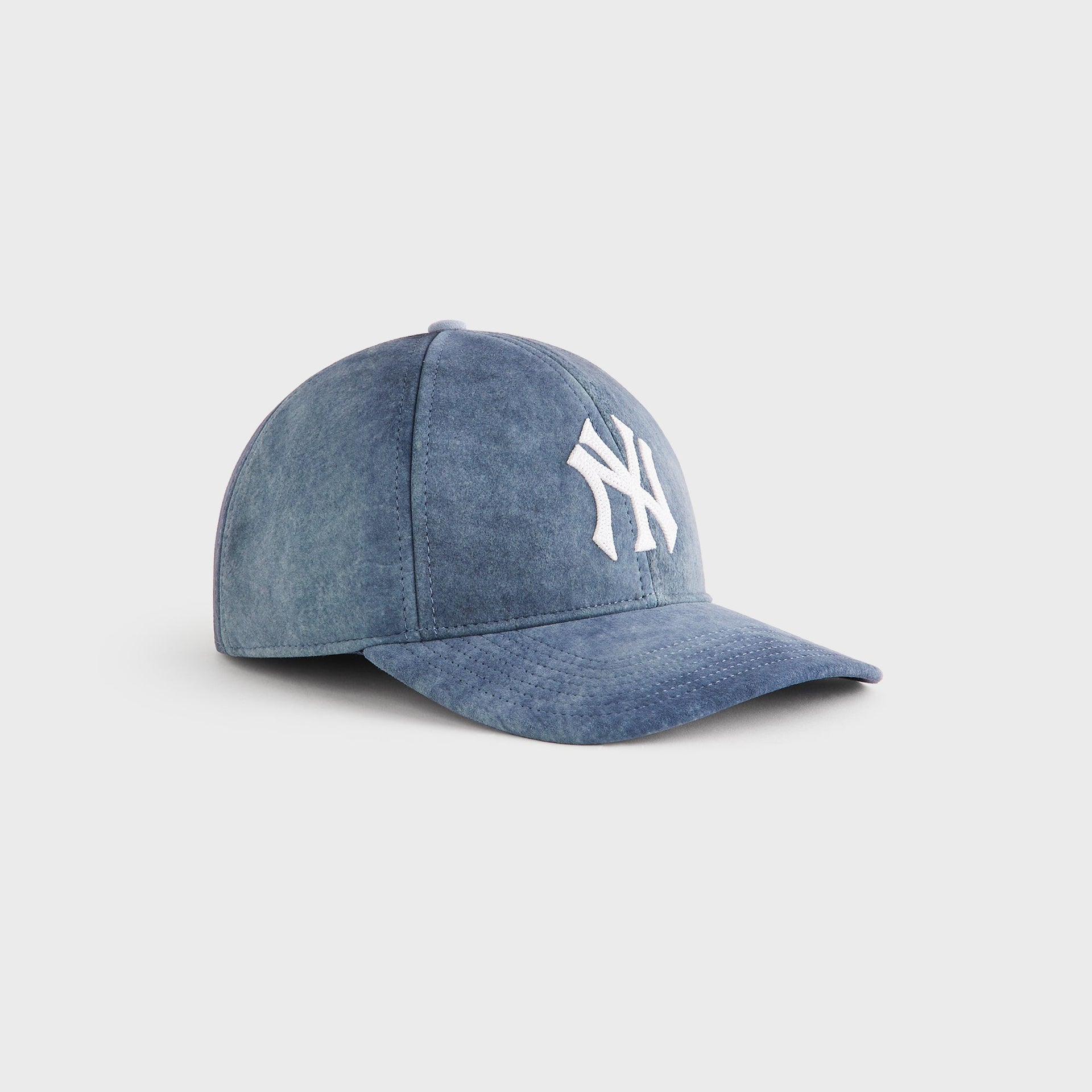 Three-quarter angle view of the Kith & '47 for the New York Yankees Washed Suede Franchise Cap in Torpedo blue suede with embroidered NY logo