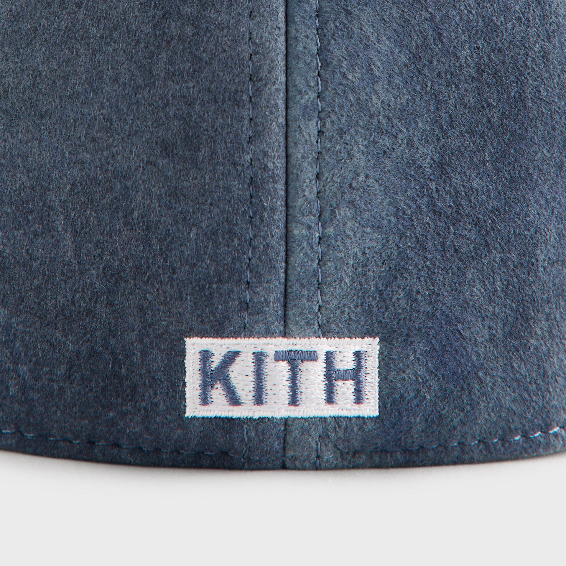 Close-up detail of the woven Kith wordmark label on the back of the '47 Washed Suede Franchise Cap in Torpedo
