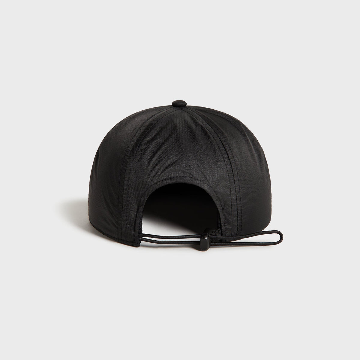 Kith Nylon Ripstop Marathon Cap in black, rear view showing bungee cord adjuster