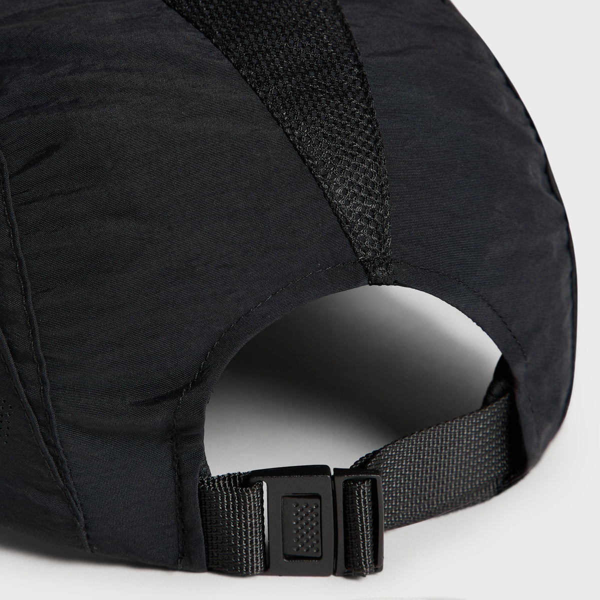 Close-up of the rear strap buckle adjuster on the Kith Nylon Mesh Paneled Griffey Camper Hat