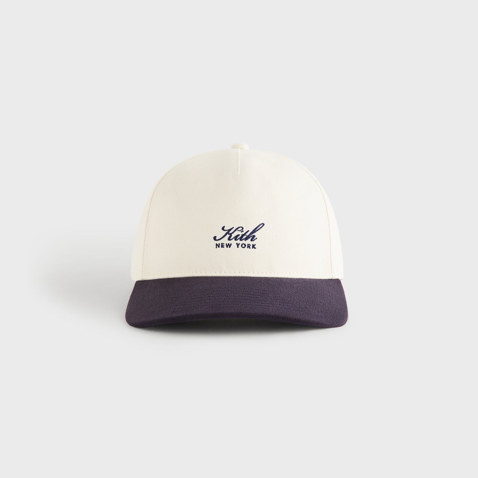 Kith Script Brushed Twill Bay Low Pinch Crown Cap in Nocturnal, front view with ivory crown and navy brim