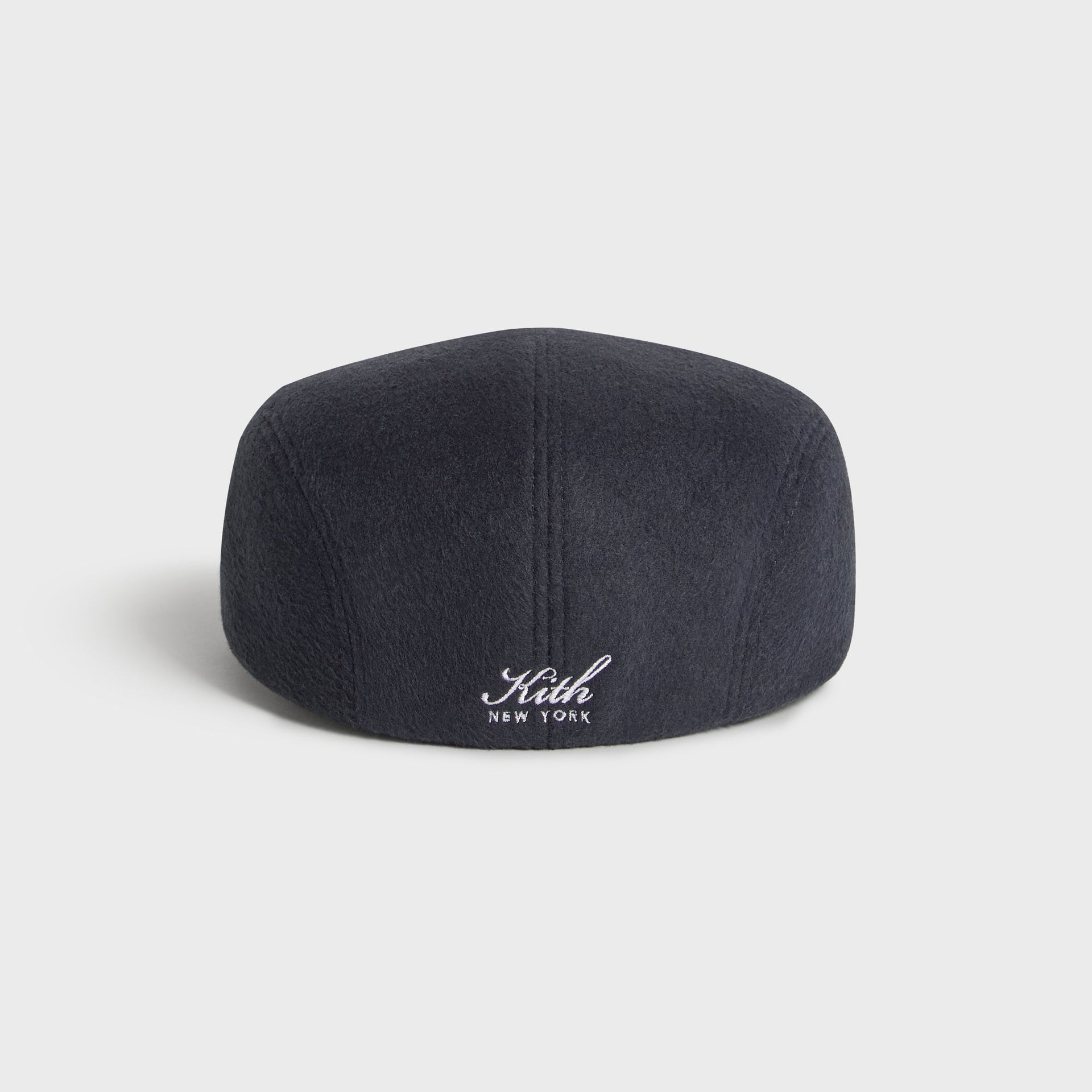 Kith Script Double-Face Wool Drivers Cap in Nocturnal charcoal, back angle view with Kith New York script embroidered above the hem.