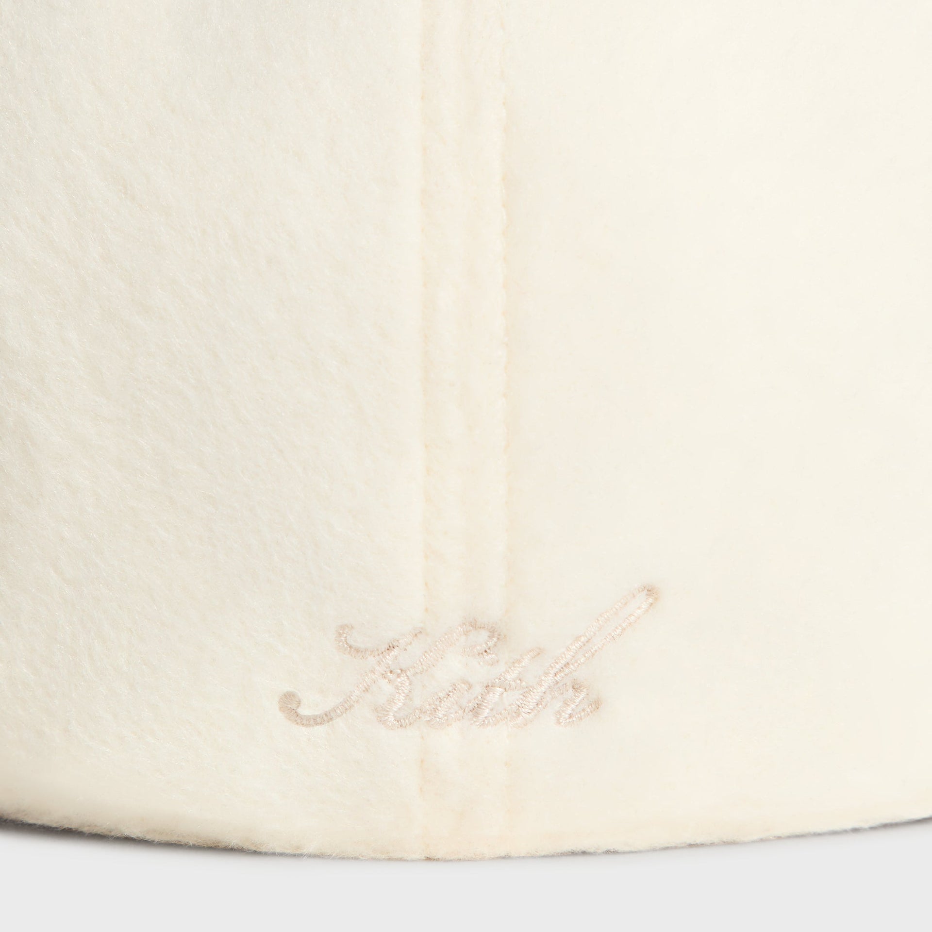Close-up of Kith script wordmark and 47 logo embroidery on Sandrift Double-Face Wool Drivers Cap