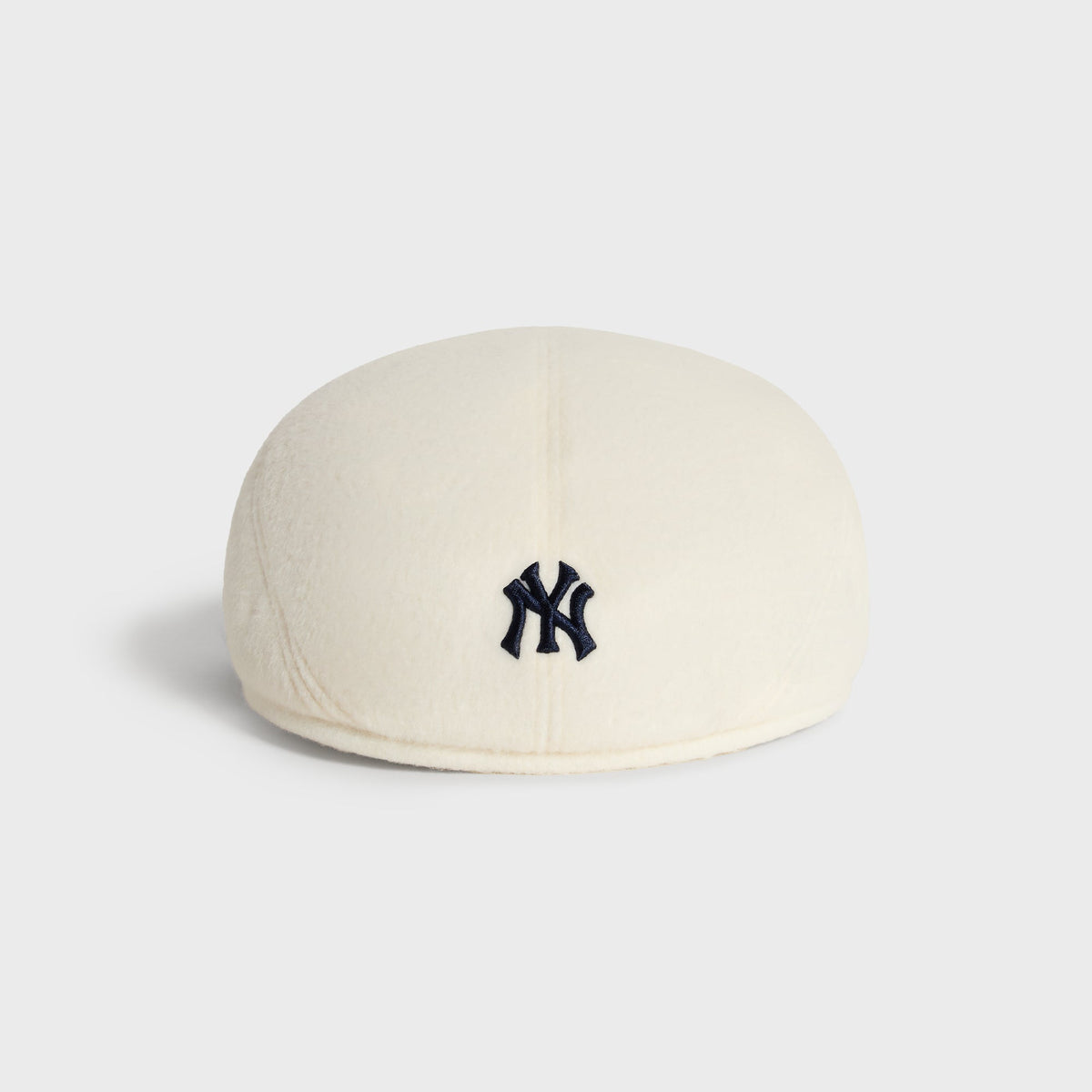 Kith & '47 Double-Face Wool Drivers Cap in Sandrift, back view showing plain ivory wool crown
