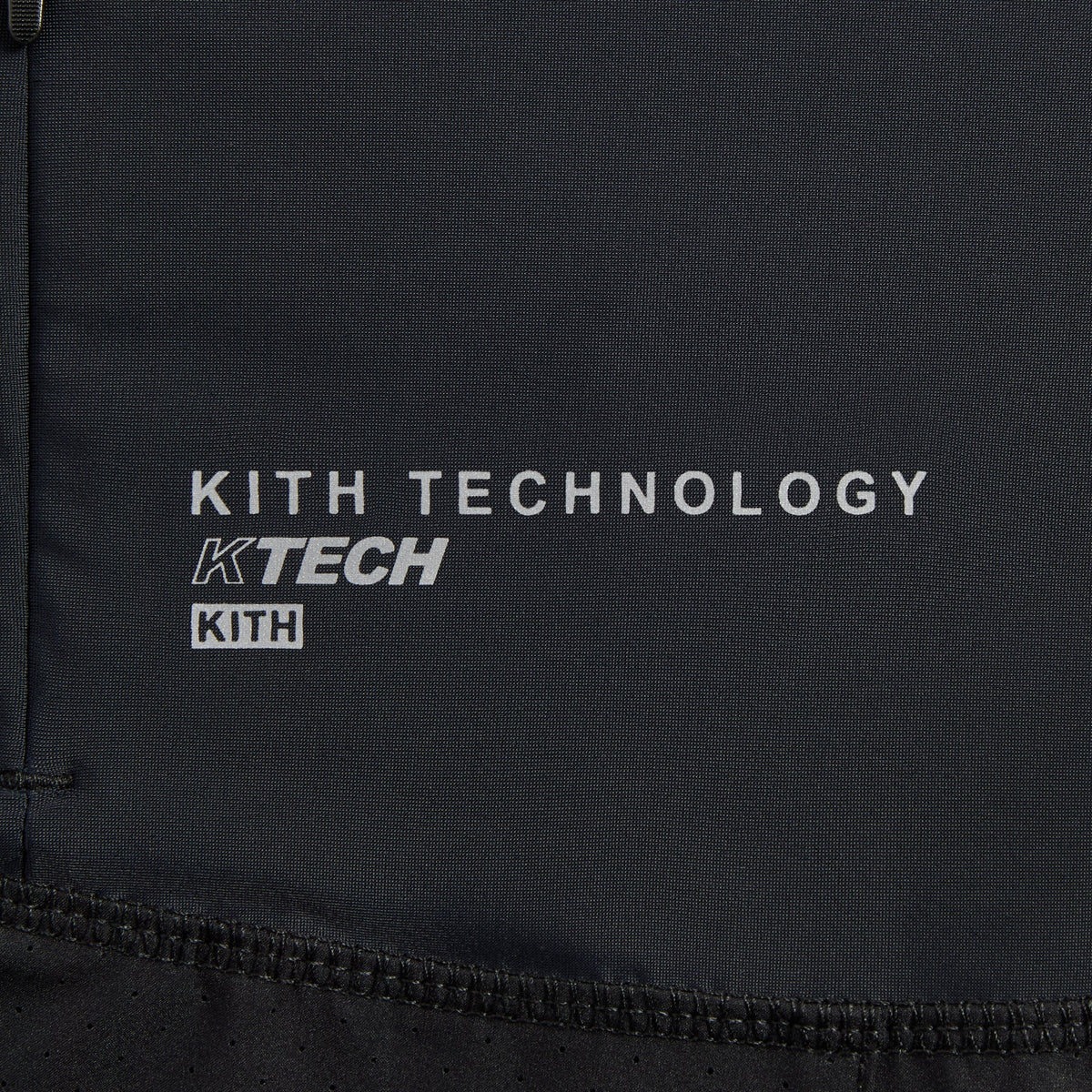 Close-up of Kith Demas 5-inch Short embroidered Kith crest logo at the hem