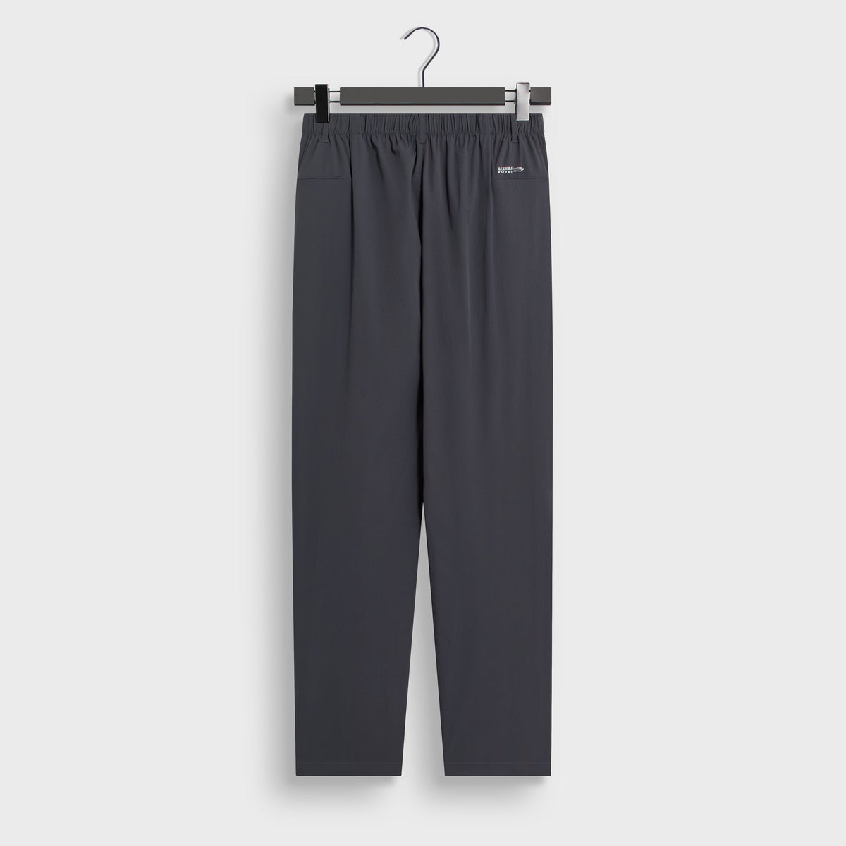 Kith Four-Way Stretch Idris Pant in charcoal grey, flat lay back view showing side pockets