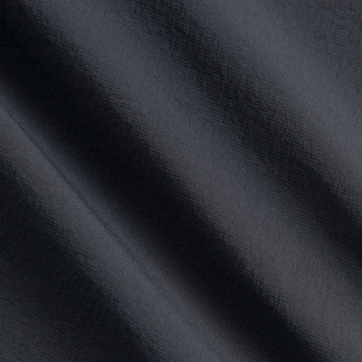 Close-up of Kith Four-Way Stretch Idris Pant charcoal ripstop fabric texture