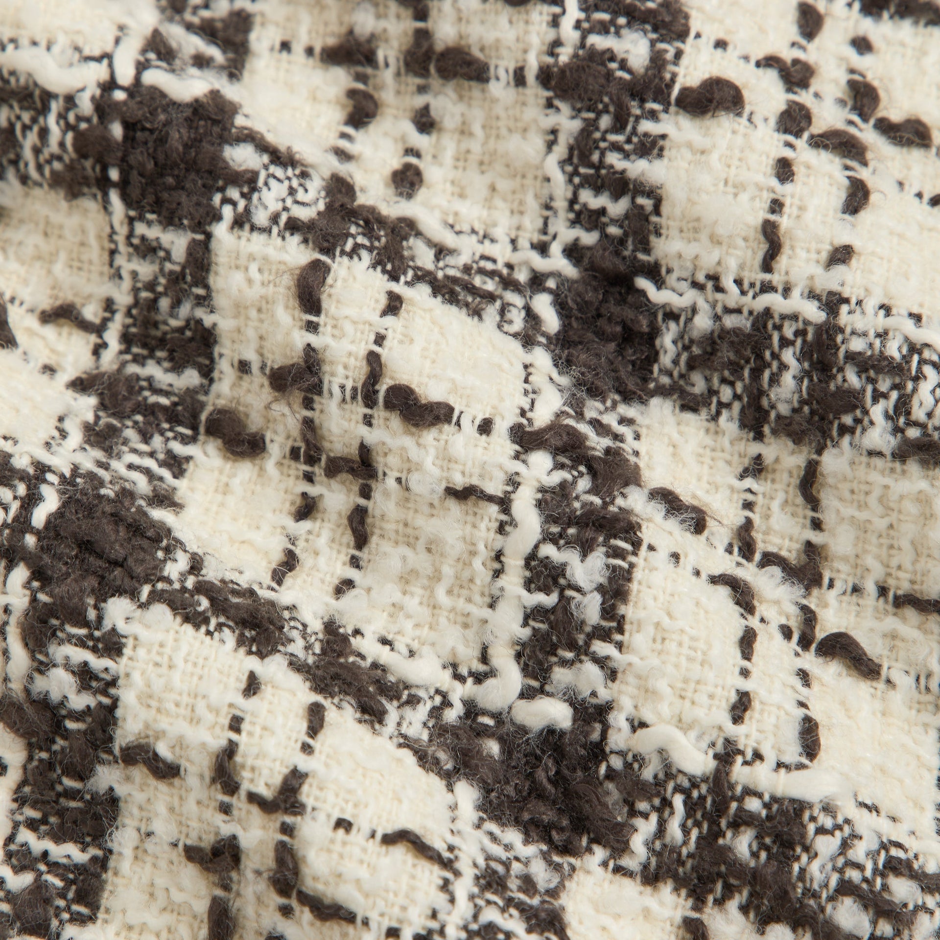 Close-up of Sandrift cream and brown boucle check tweed of the &Kin Hawthorne Flight Jacket