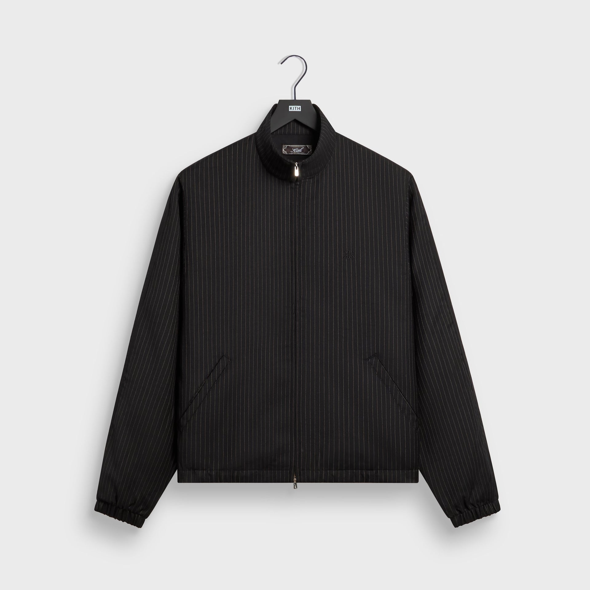 Kith Pinstripe Rui track jacket in black with subtle pinstripe weave, front flat lay