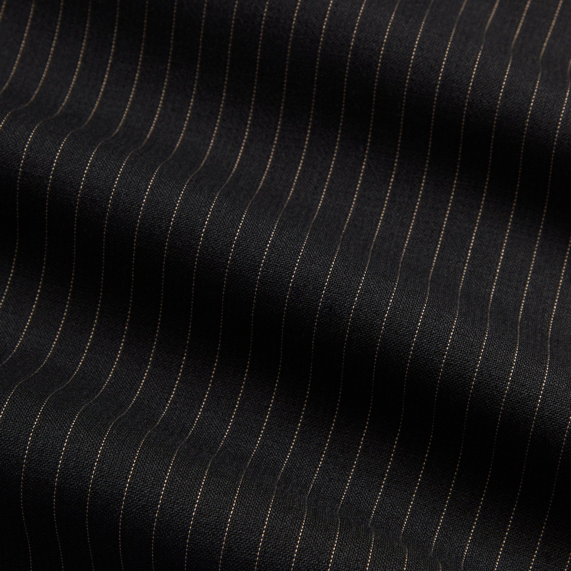 Close-up of the black and tan pinstripe fabric weave on the Kith Pinstripe Rui track jacket