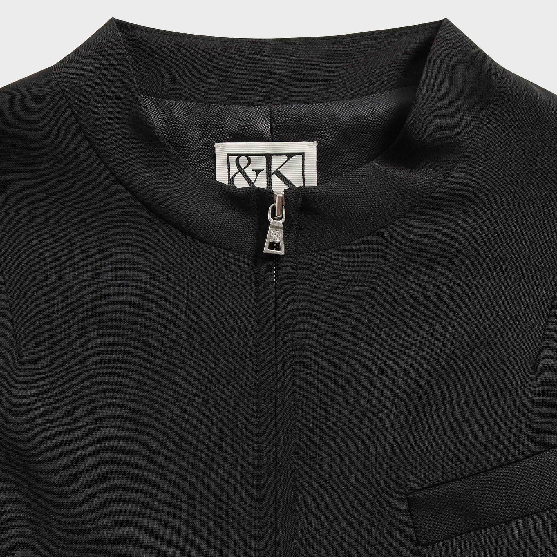 &Kin Denez Jacket detail: band collar, &Kin woven label and silver zip pull, black
