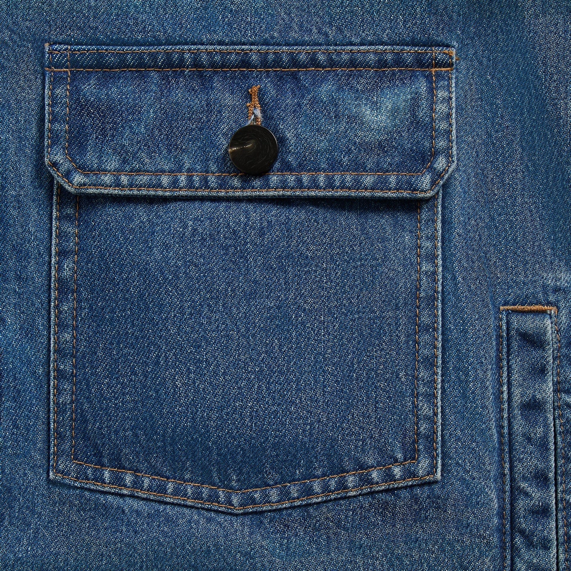 &Kin Clint Trucker Jacket detail, buttoned flap chest pocket with black button on River Indigo denim