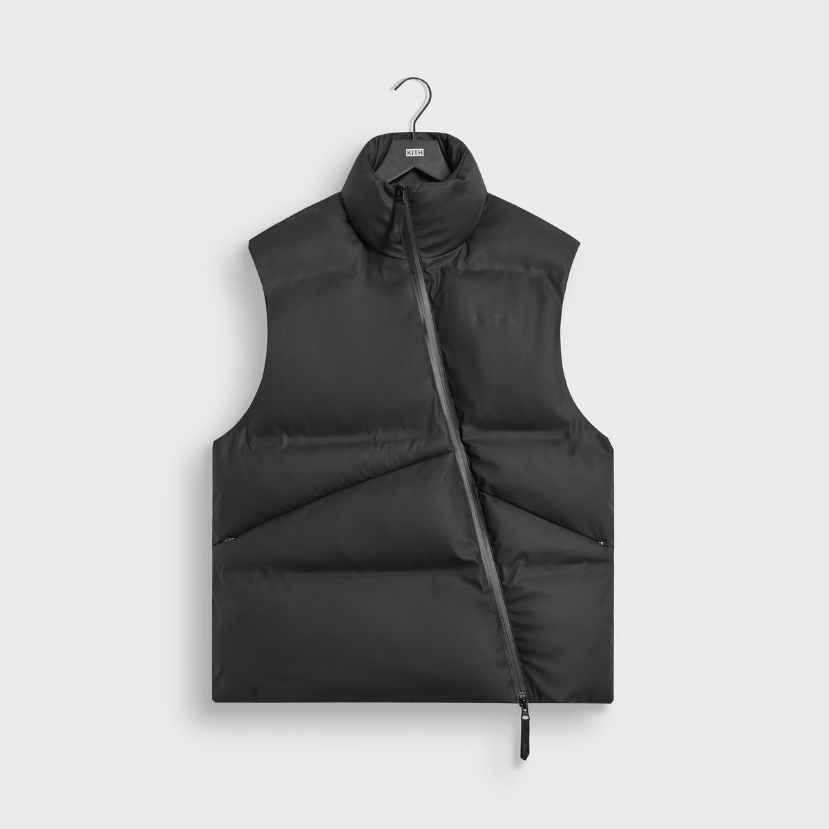 Kith Stretch Poly Filmore Puffer Vest in black, front view, with asymmetric zip and stand collar