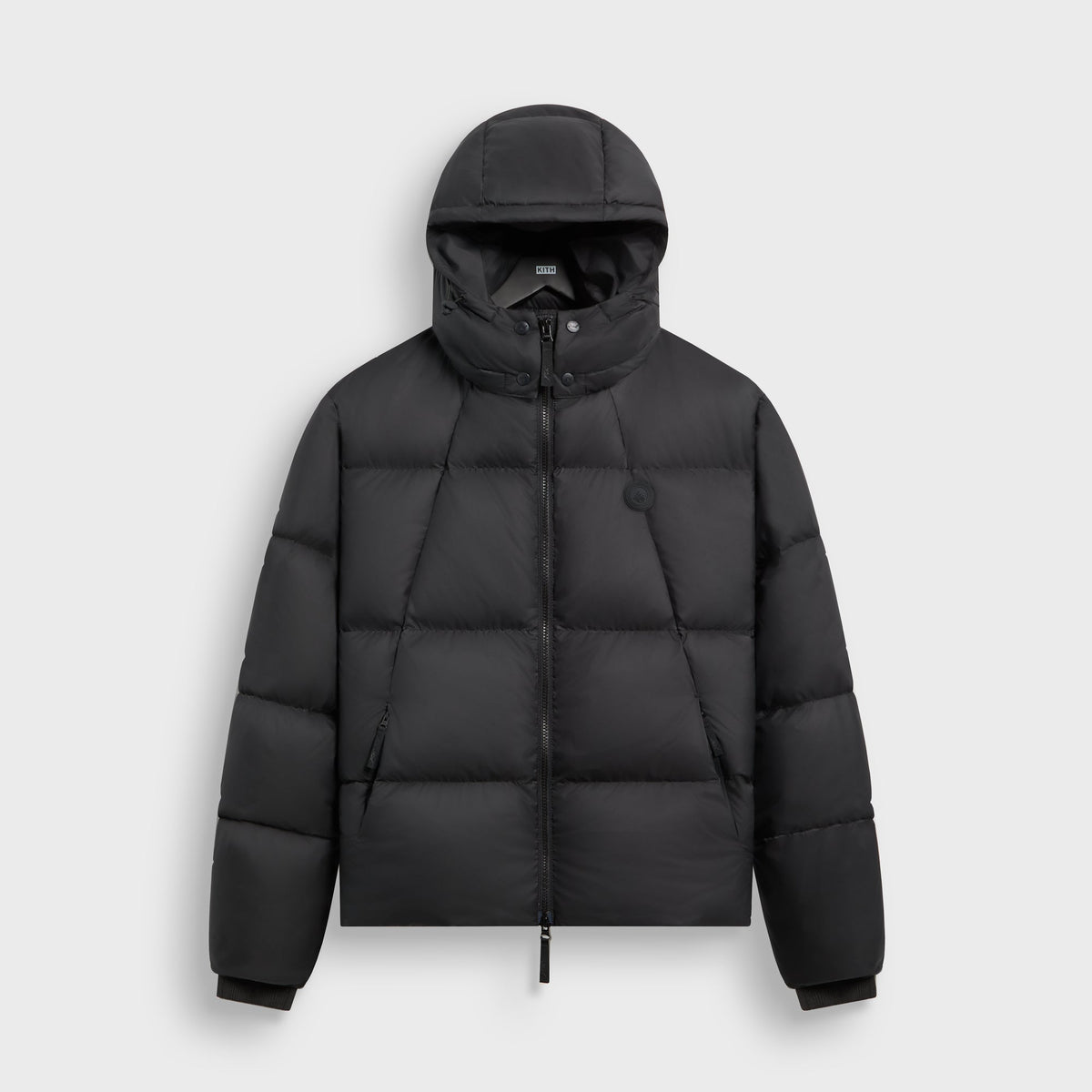 Kith Matte Stretch Taffeta Midi Puffer in black, front view, hooded zip puffer jacket