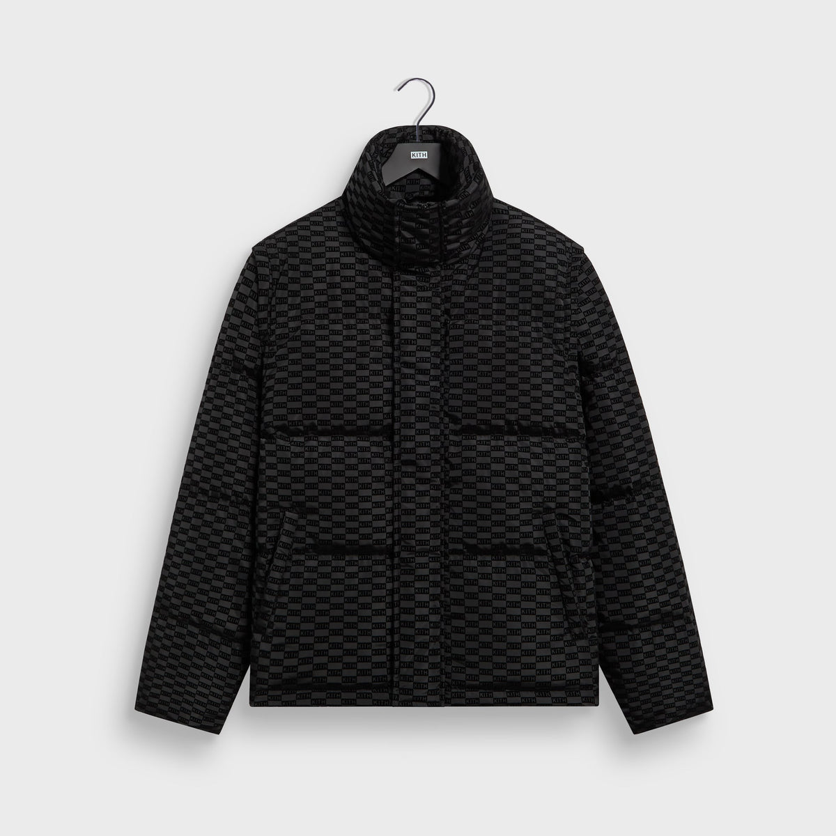 Kith Flocked Monogram Westley Convertible Puffer in black with tonal monogram flocking, front view