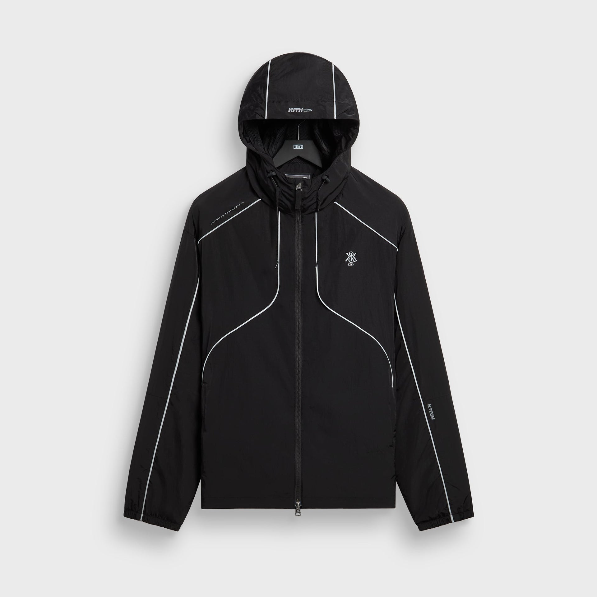 Kith Nylon Bolt shell jacket in black with reflective piping and hood, front flat lay