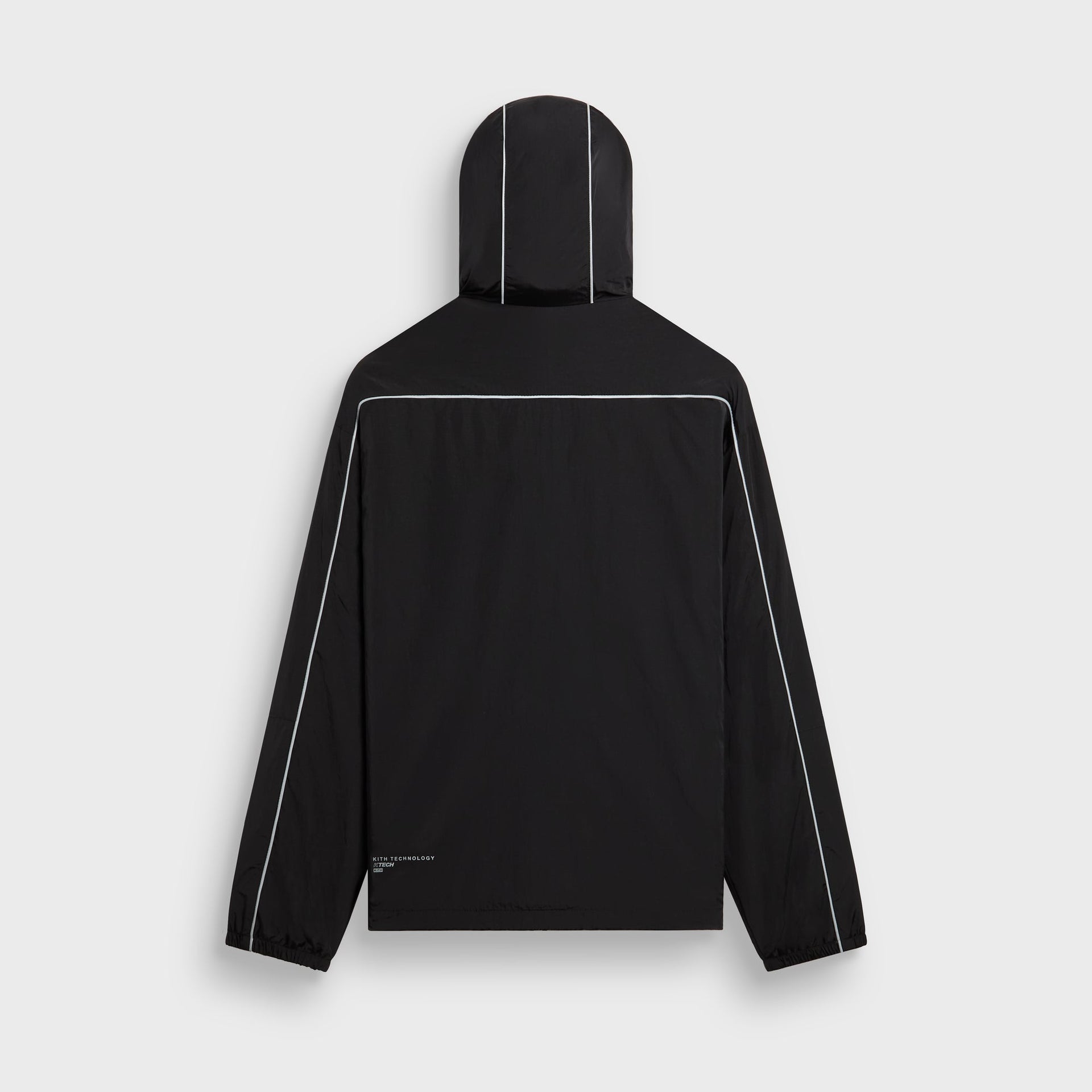 Kith Nylon Bolt shell jacket in black with reflective piping, back flat lay