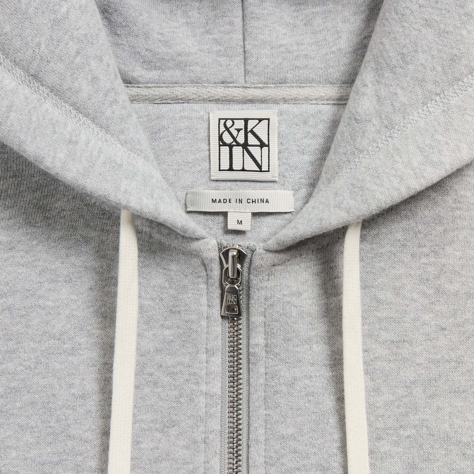 &Kin Plush Fleece Hiroshi Hoodie detail, hood with &Kin label, silver zip pull and cream drawstrings