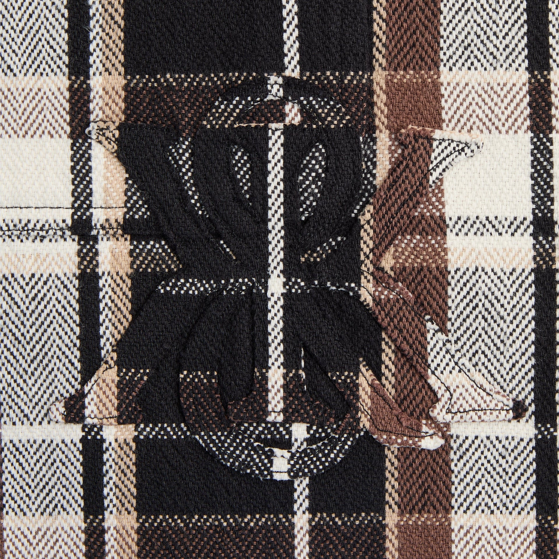 Close-up of the embroidered ampersand K logo patch on the Kith Plaid Henson buttondown shirt