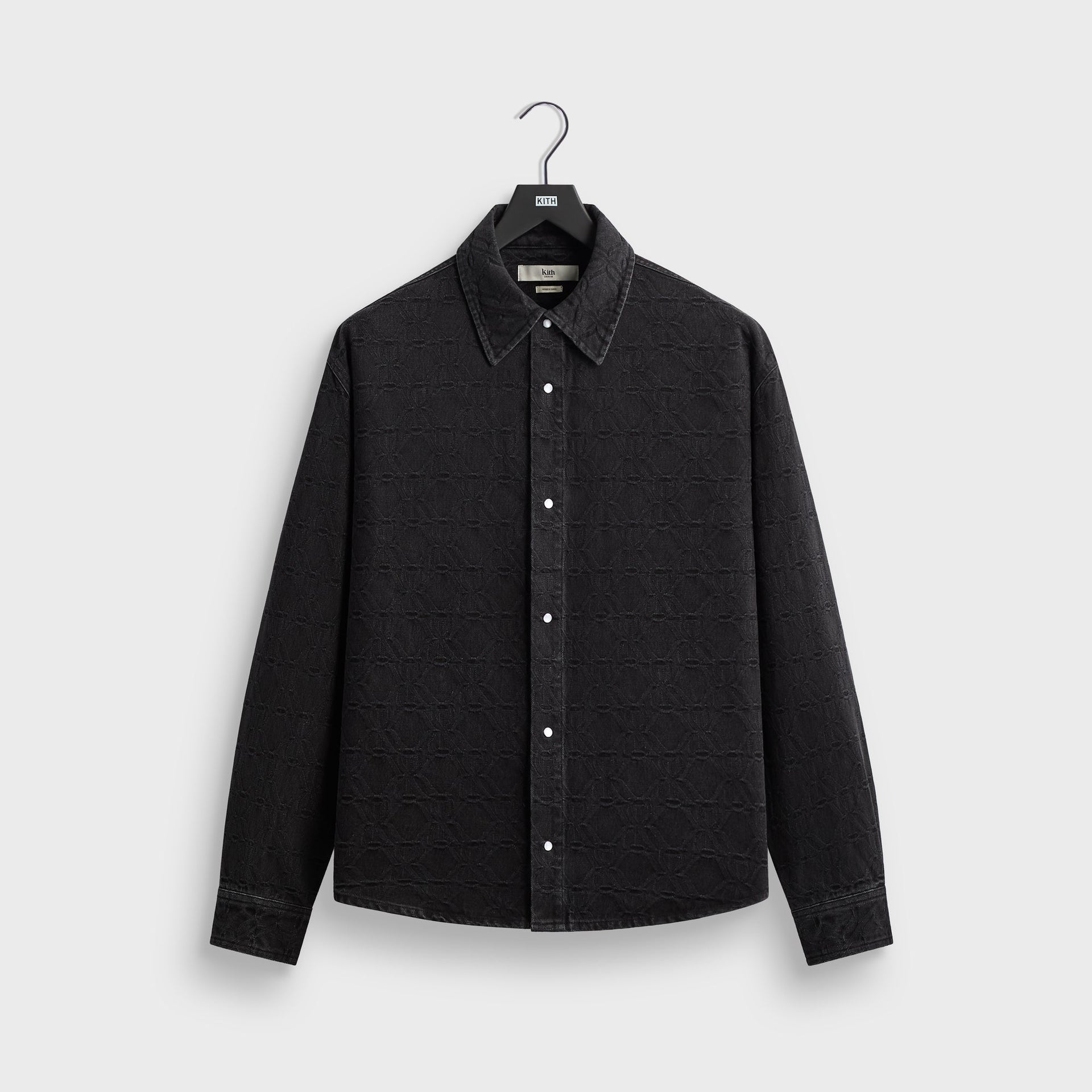Kith Jacquard Crest Apollo shirt in black denim with tonal crest jacquard pattern, front flat lay