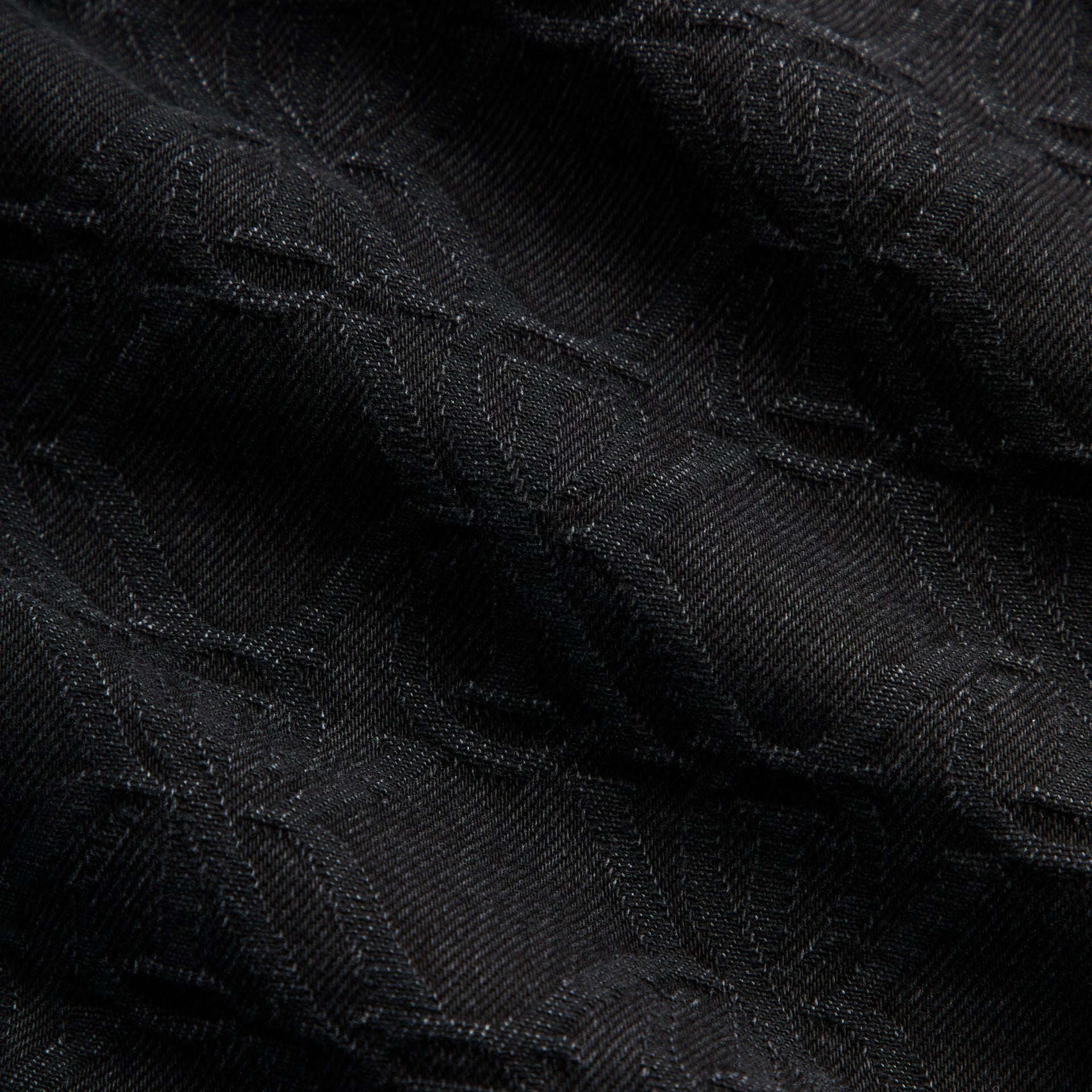 Close-up of the tonal crest jacquard denim texture on the Kith Apollo shirt