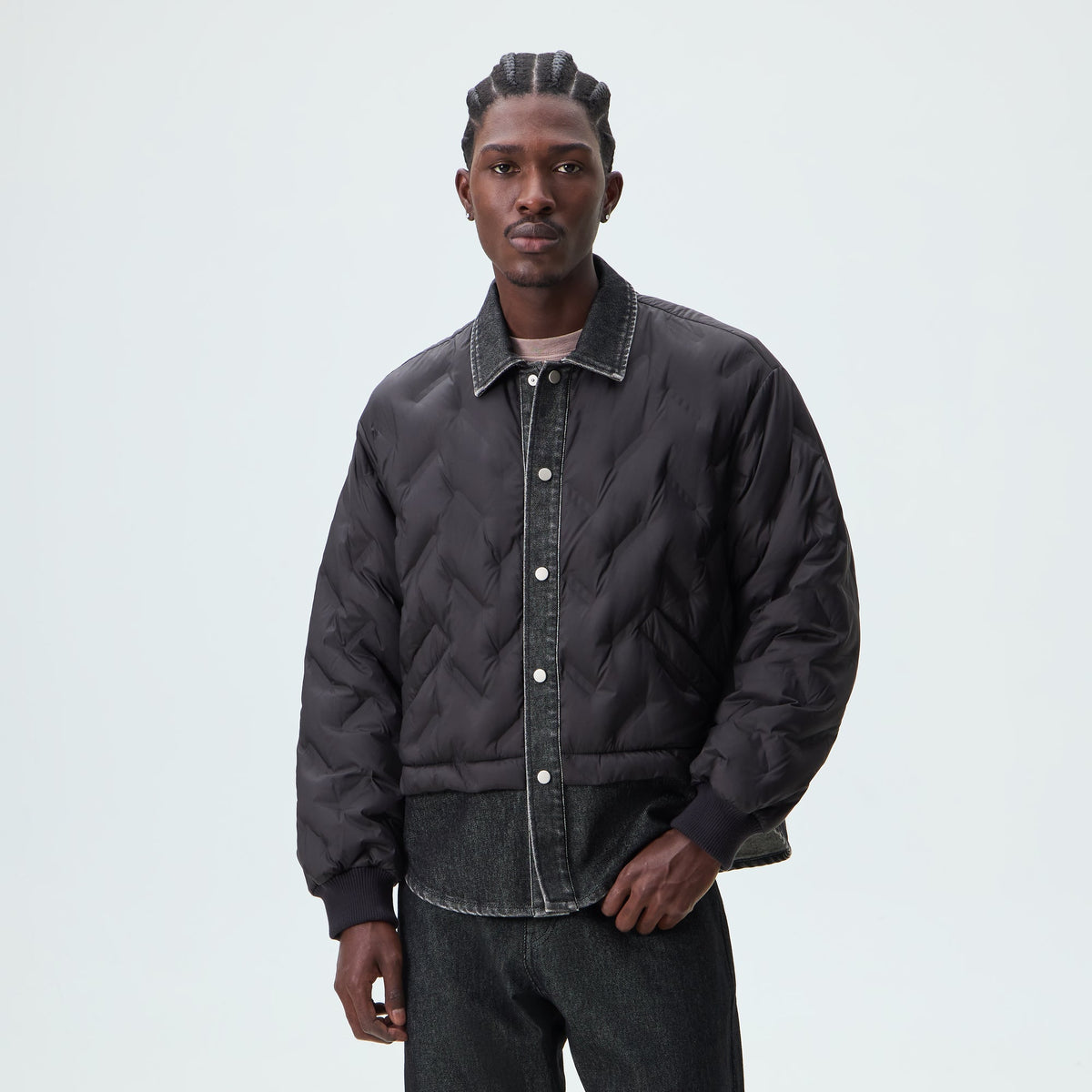 Man wearing black Kith Quilted Denim Gertie shirt jacket, front view