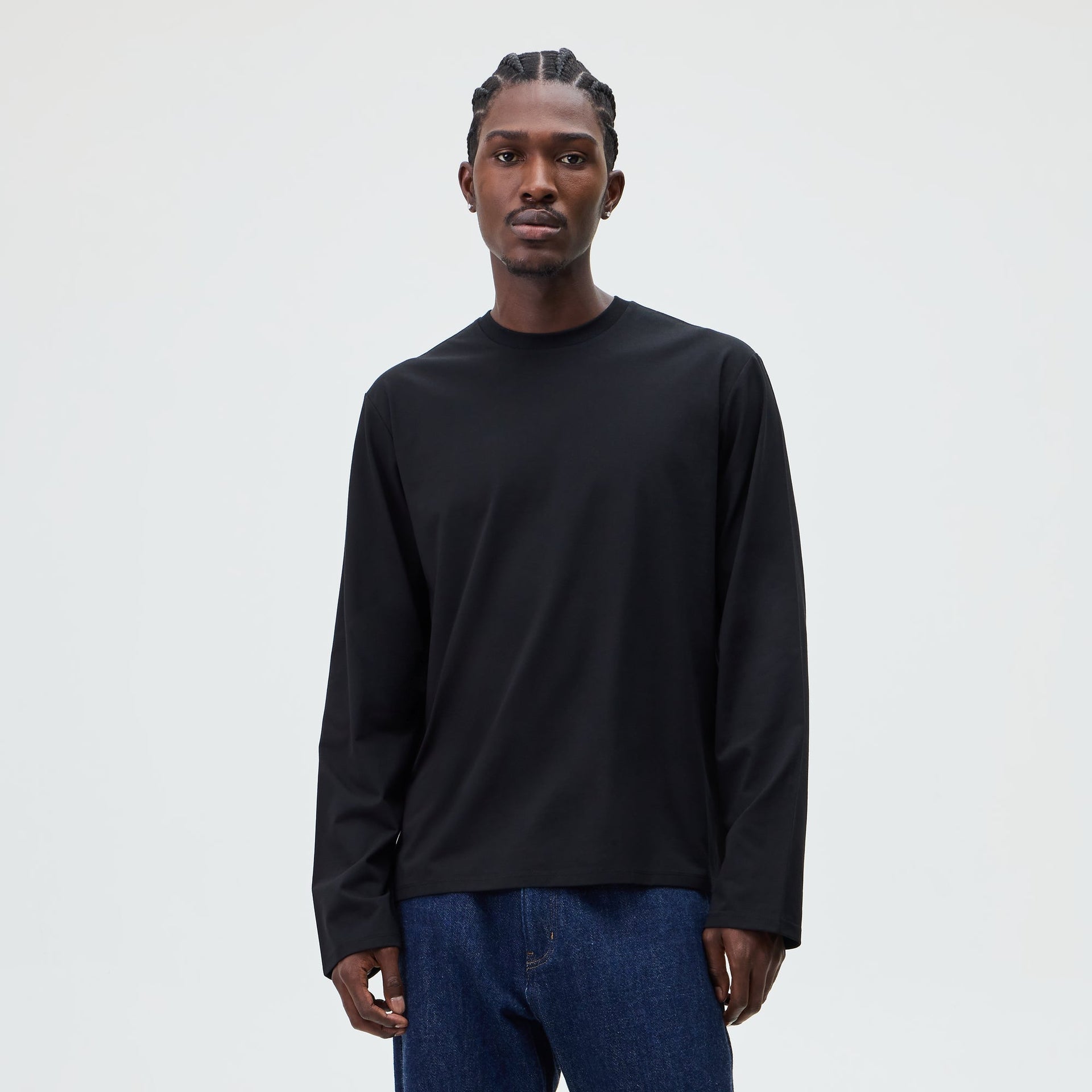 &Kin Long Sleeve Halston Tee in black worn by a model with dark denim jeans, front view