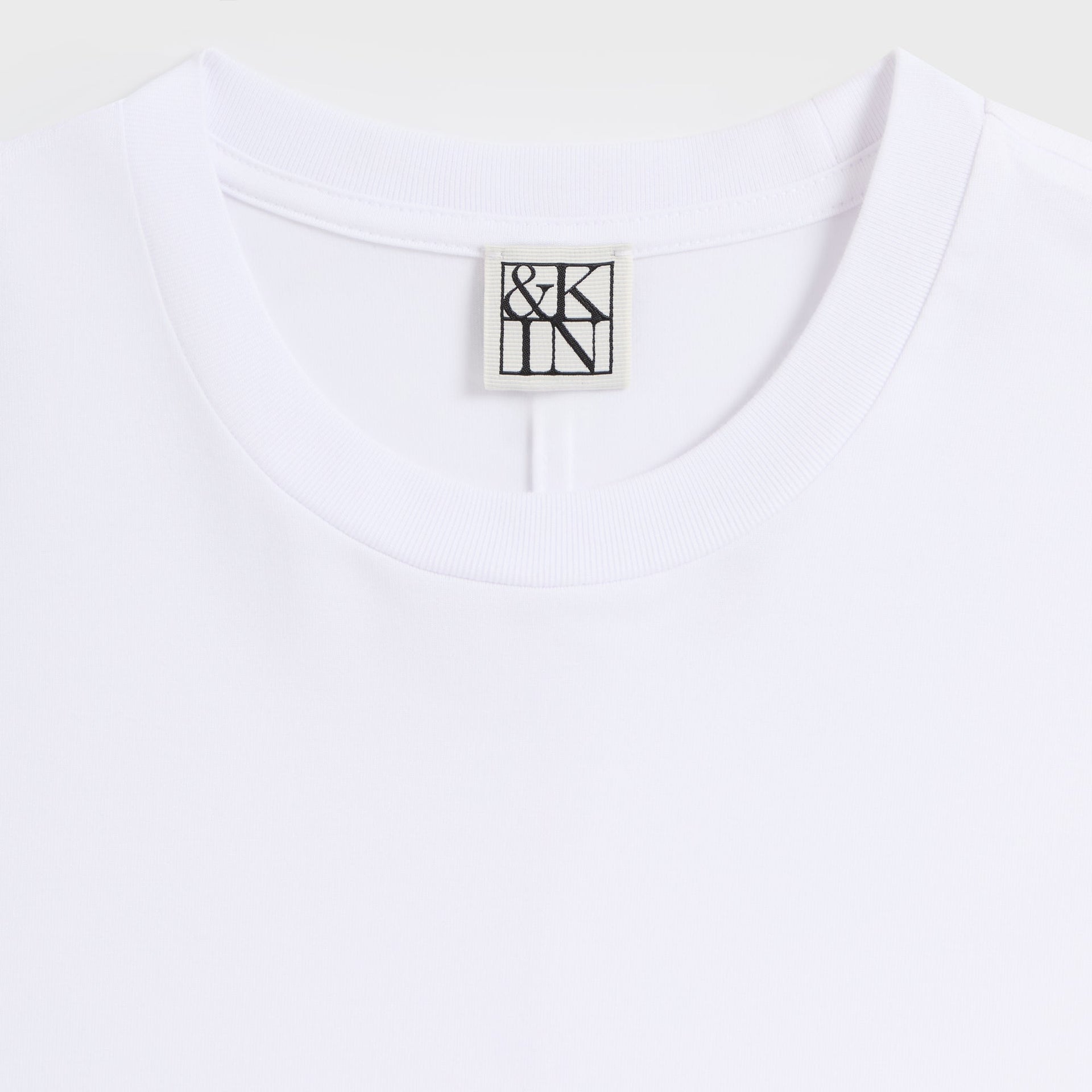 &Kin Halston Tee detail: ribbed crew collar with woven &Kin logo label on white cotton