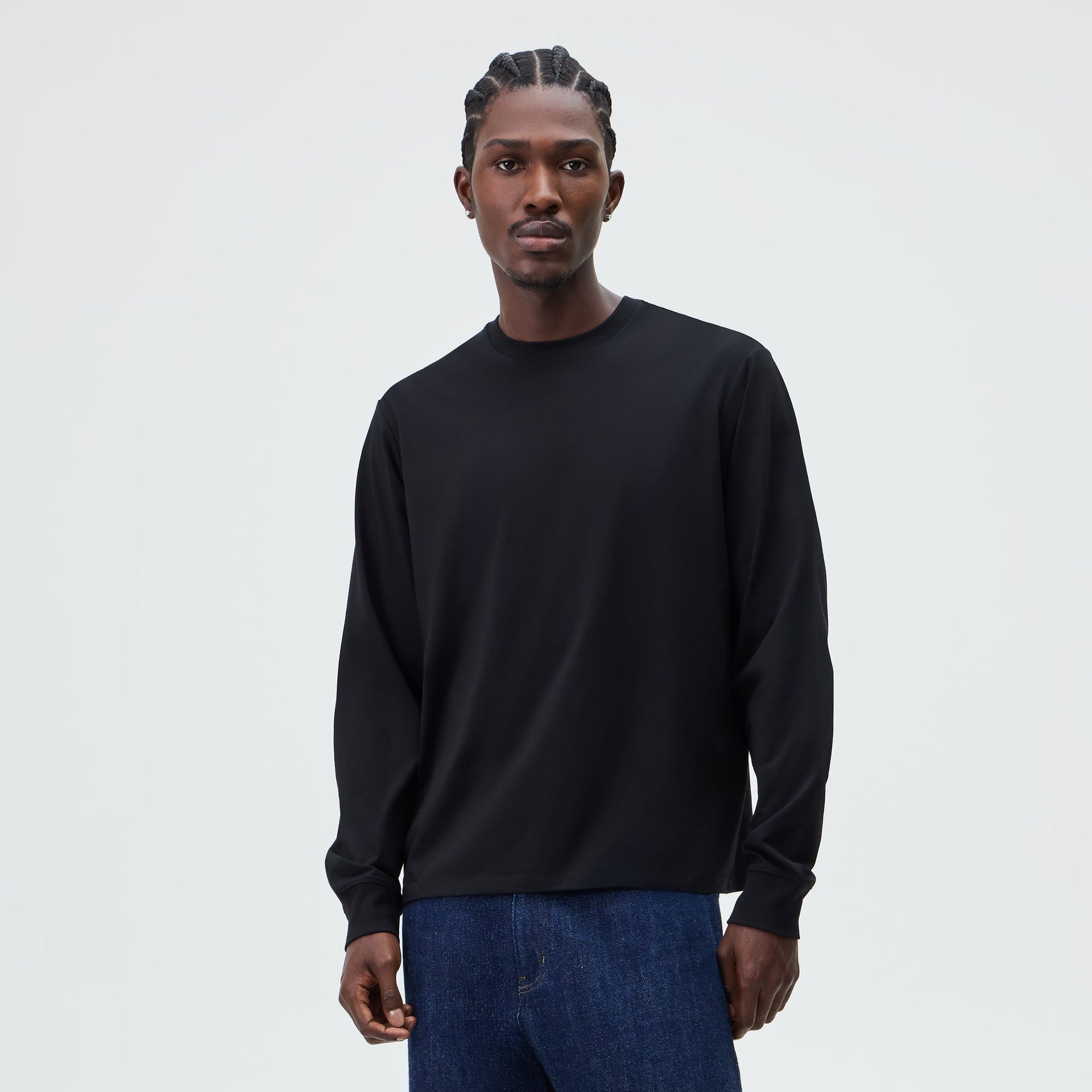 &Kin Long Sleeve Darin Tee in black worn by a model with dark denim jeans, front view