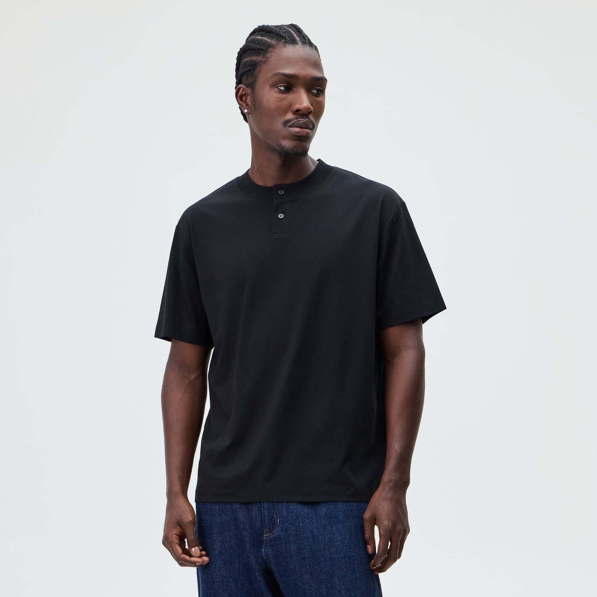 &Kin Albie Henley Tee in black worn by a model with dark denim jeans, front view