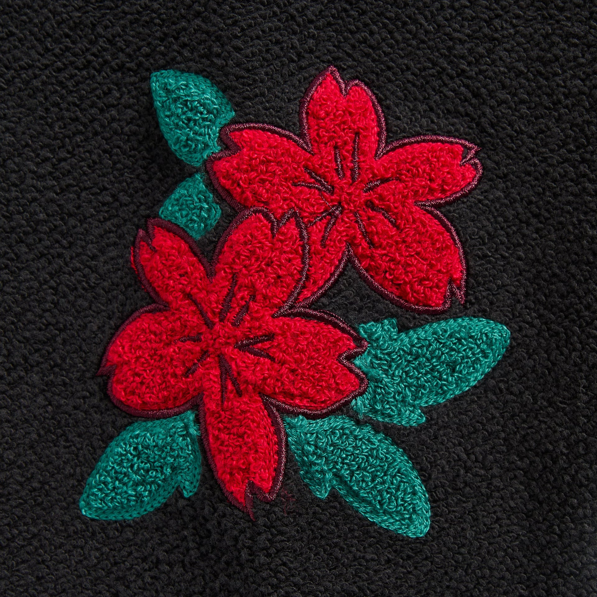 Close-up of the red and green floral embroidery on the Kith Varsity Lawson crewneck