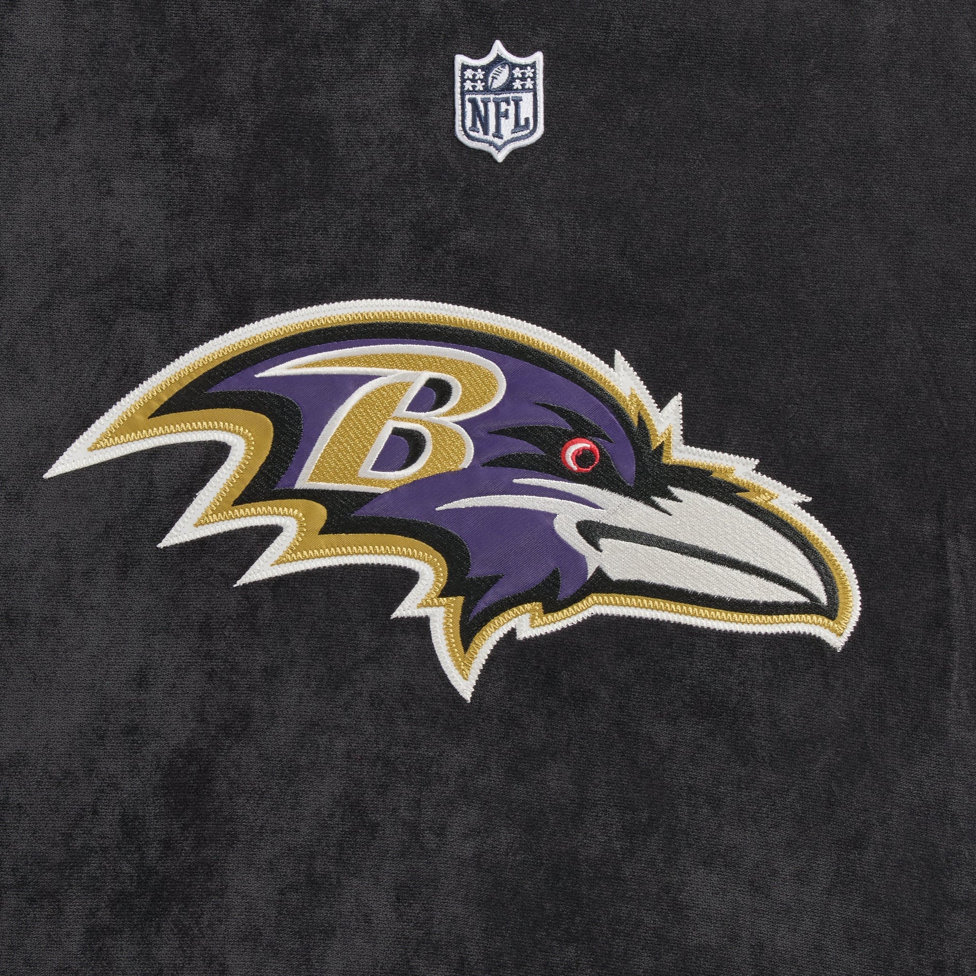 Close-up of the Baltimore Ravens logo patch on the Kith NFL Leon shirt