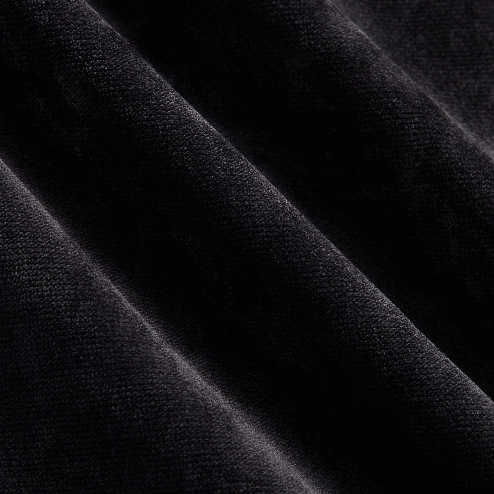 Close-up of the black jersey fabric texture on the Kith NFL Raiders Leon shirt