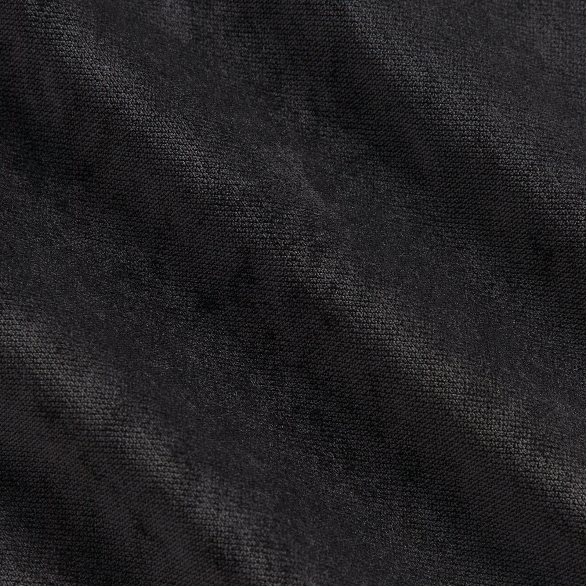Close-up of the black jersey fabric texture on the Kith NFL Falcons Leon shirt