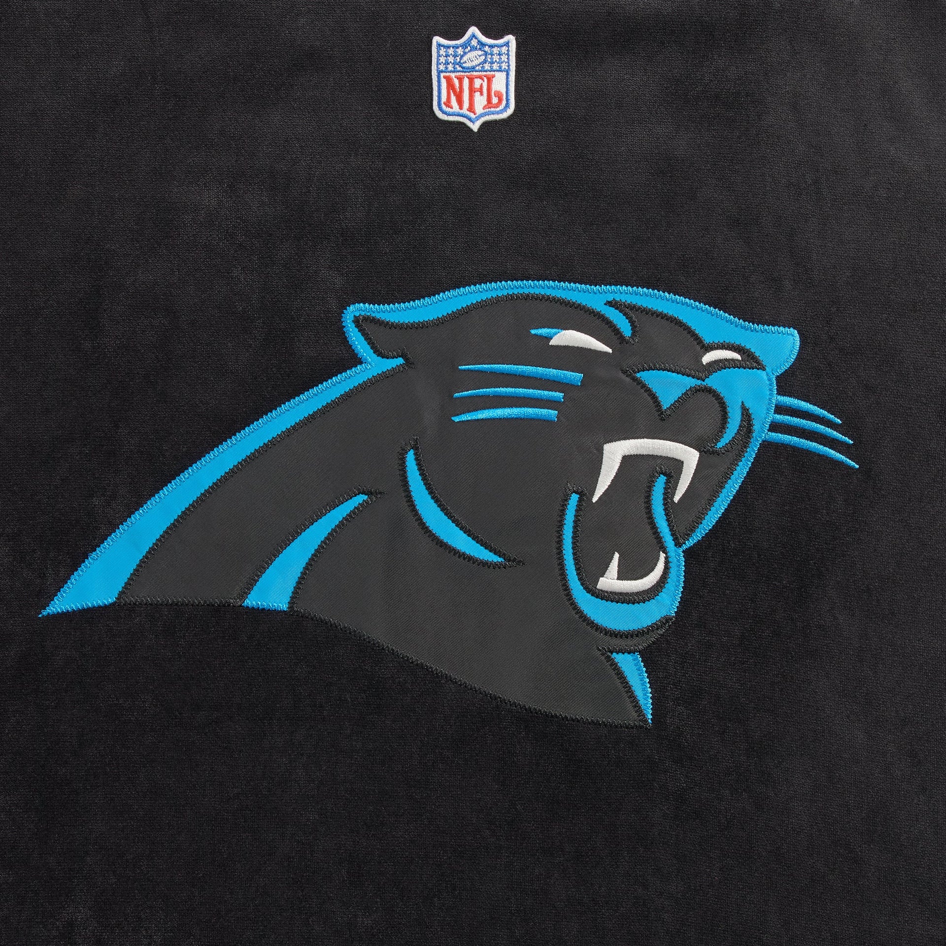 Close-up of the Carolina Panthers logo patch on the Kith NFL Leon shirt