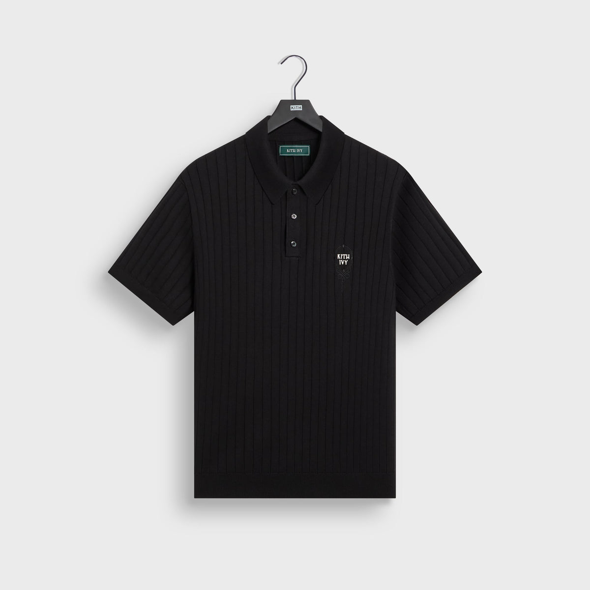 Kith Ivy Knit Tilden Polo in black on hanger, front view with vertical rib knit and small embroidered KITH IVY logo